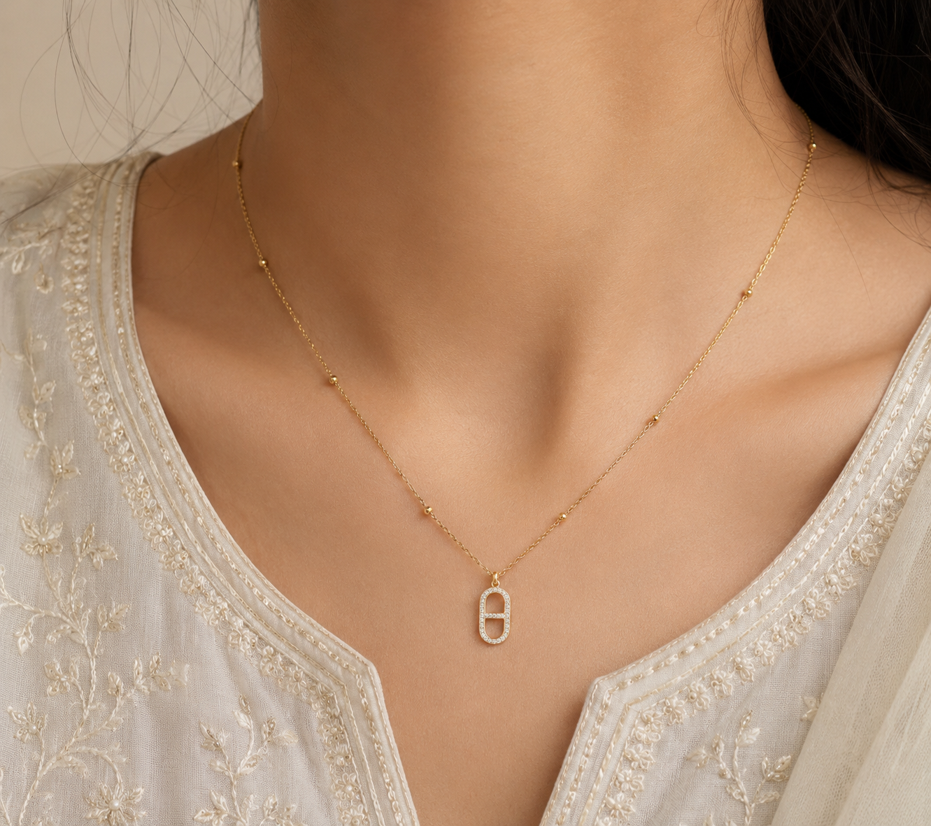 Women Wearing Gold Crystal Oval Link Pendant Necklace with Sparkling Stones and Beaded Chain for Women