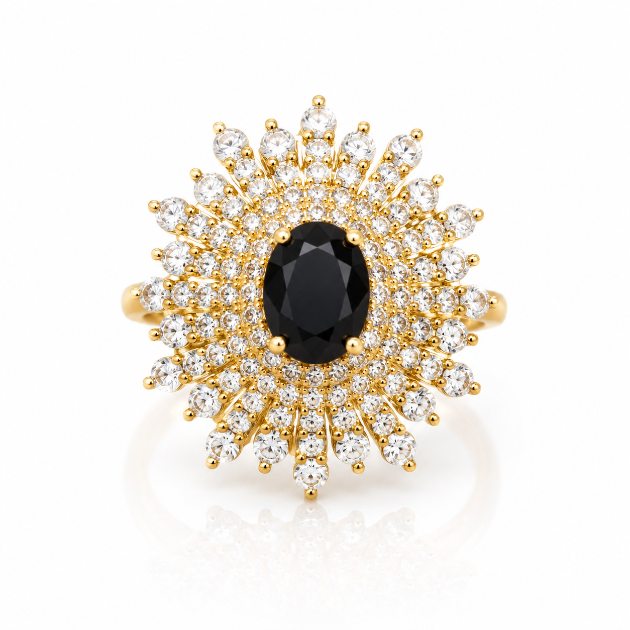 Gold-tone statement ring featuring a black oval crystal surrounded by multiple rows of sparkling round zircon stones in a radiant halo design.