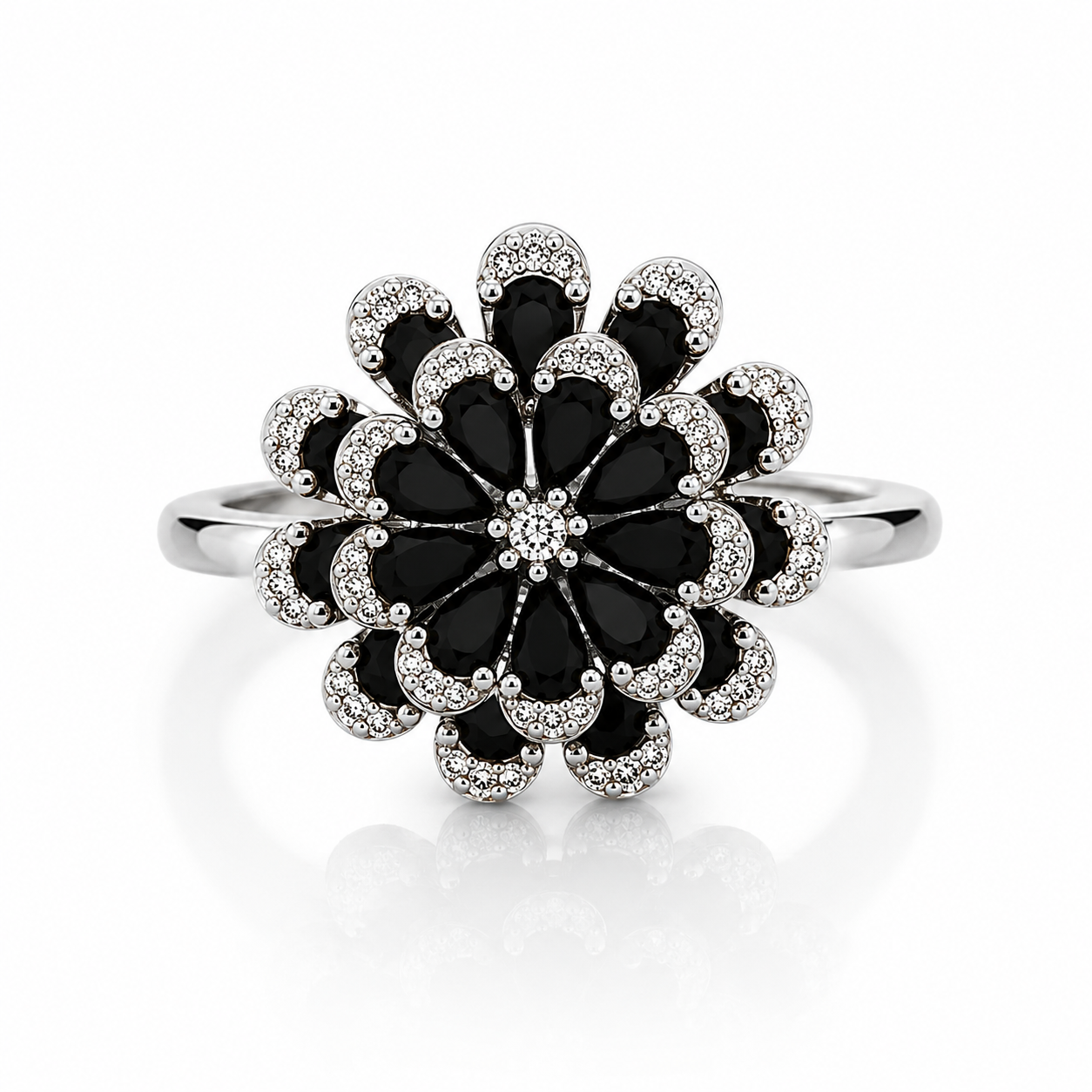 Silver floral statement ring featuring layered black pear-cut crystals with sparkling pavé zircon accents and a brilliant crystal center.