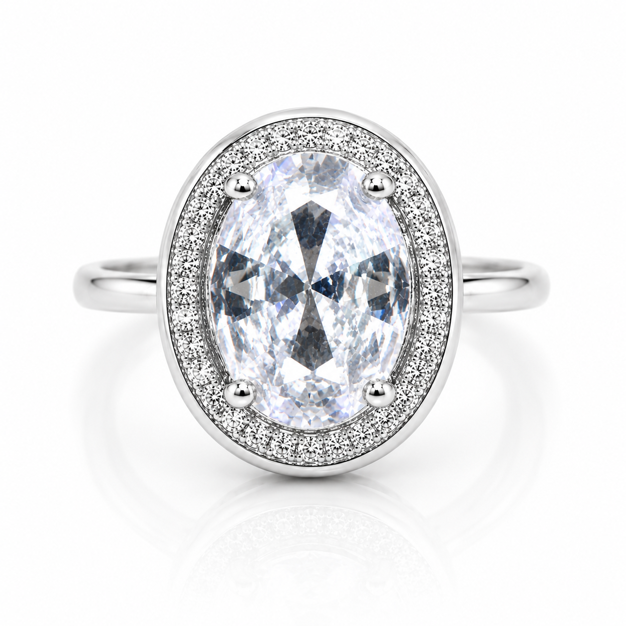 Silver-tone ring featuring a large oval-cut clear crystal surrounded by a sparkling pavé zircon halo with a polished solid band.