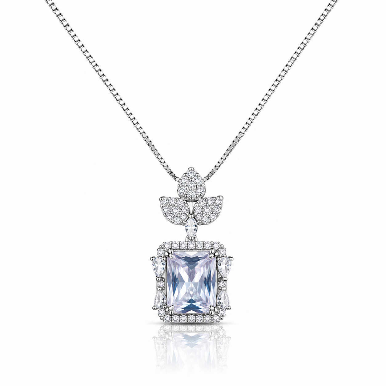 Silver pendant necklace featuring a princess-cut crystal surrounded by sparkling zircon stones with an elegant floral-inspired top design on a delicate box chain.