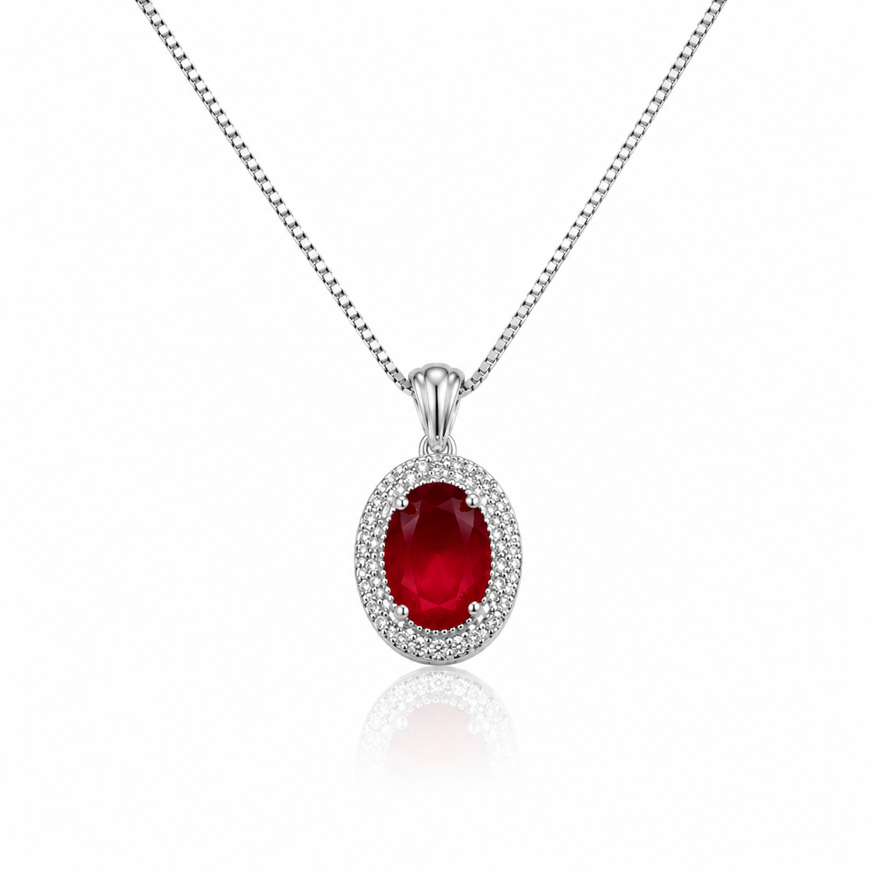 Elegant silver pendant necklace featuring a ruby-red oval crystal surrounded by sparkling zircon stones on a delicate box chain.
