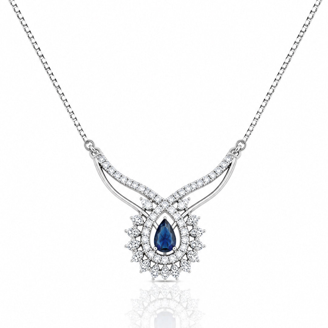Silver statement necklace featuring a pear-shaped royal blue crystal surrounded by sparkling zircon stones with an elegant curved silver design.